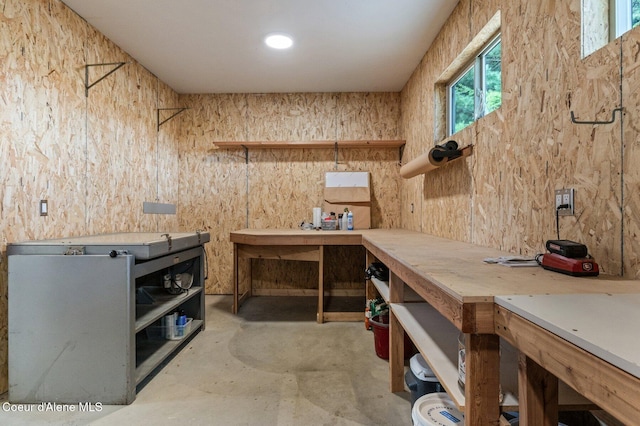 miscellaneous room featuring concrete floors and a workshop area
