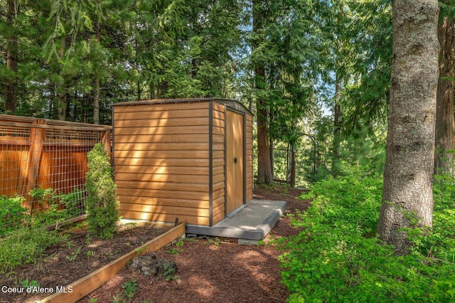view of shed with fence