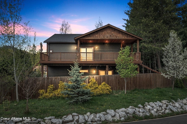view of front of house with fence and a deck