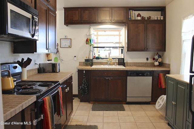 kitchen featuring a sink, tile counters, stainless steel dishwasher, black range with electric cooktop, and dark brown cabinets