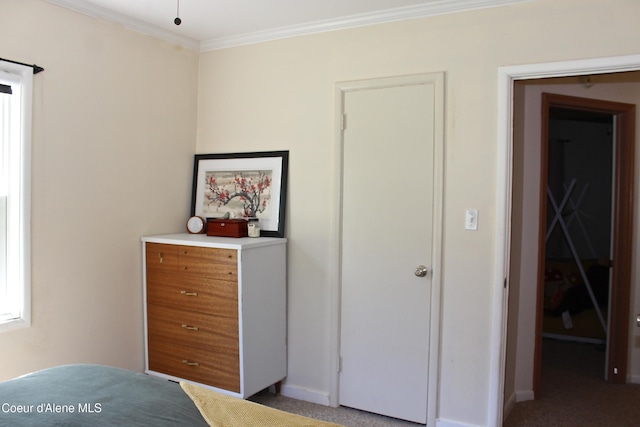 bedroom featuring light carpet, baseboards, and ornamental molding