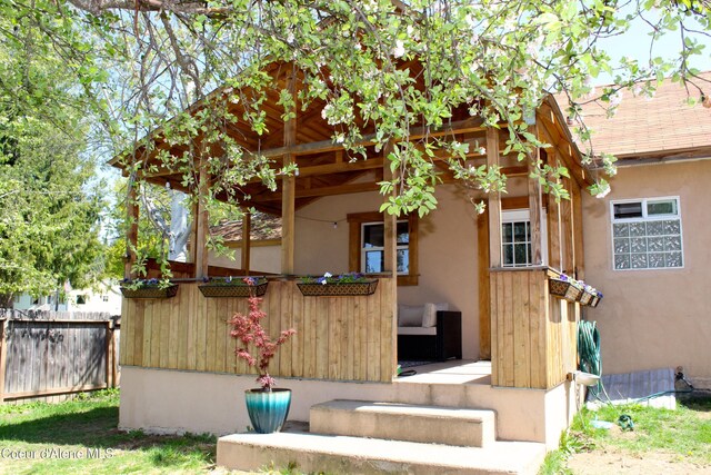 view of front of house with fence and stucco siding