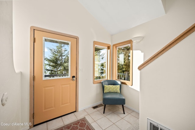 3338 Bottle Bay Rd, Sagle, ID 83860 - entryway featuring plenty of natural light, baseboards, light tile patterned flooring, and vaulted ceiling