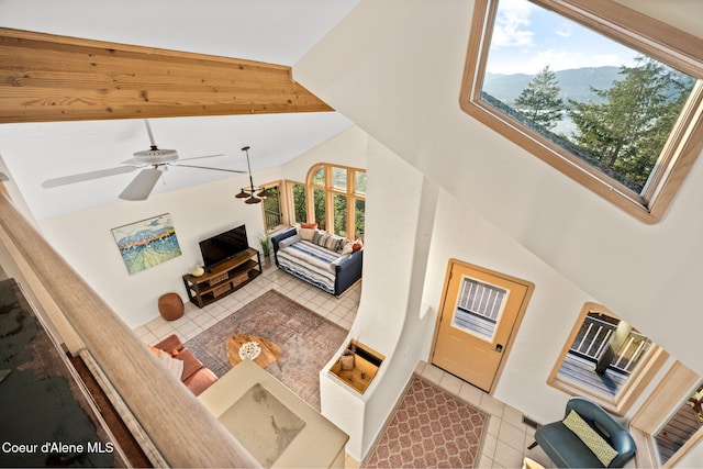 3338 Bottle Bay Rd, Sagle, ID 83860 - living area with light tile patterned floors, a ceiling fan, and vaulted ceiling