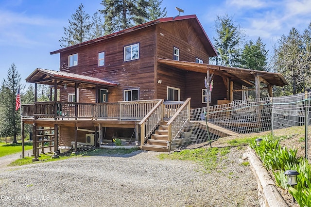 rustic home featuring stairs and a deck