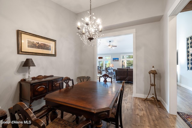 5867 W Sparrowhawk Dr, Rathdrum, ID 83858 - dining area with ceiling fan with notable chandelier, baseboards, and wood finished floors