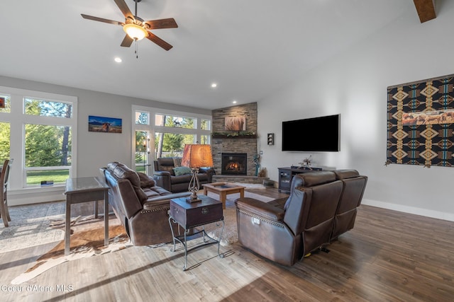 5867 W Sparrowhawk Dr, Rathdrum, ID 83858 - living room featuring baseboards, lofted ceiling, wood finished floors, ceiling fan, and a fireplace
