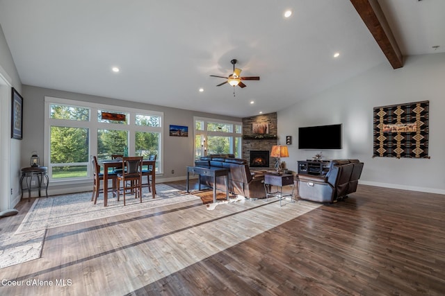 5867 W Sparrowhawk Dr, Rathdrum, ID 83858 - living area featuring wood finished floors, lofted ceiling with beams, ceiling fan, a fireplace, and baseboards