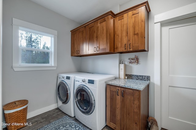 5867 W Sparrowhawk Dr, Rathdrum, ID 83858 - laundry room featuring dark wood finished floors, washer and dryer, baseboards, and cabinet space