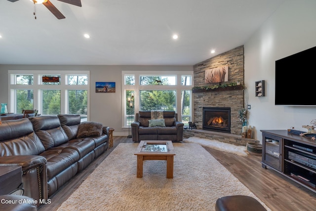 5867 W Sparrowhawk Dr, Rathdrum, ID 83858 - living area with vaulted ceiling, a ceiling fan, a stone fireplace, wood finished floors, and recessed lighting