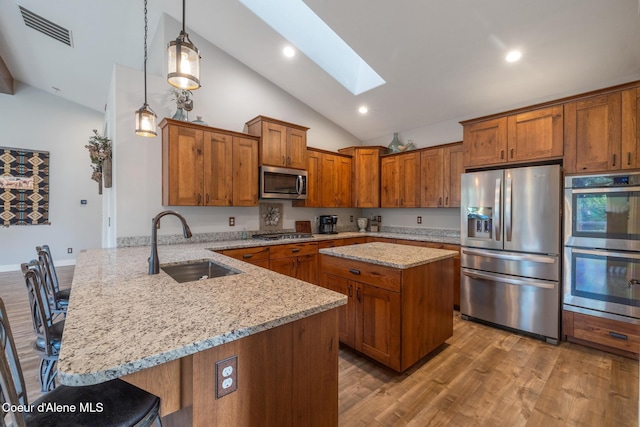5867 W Sparrowhawk Dr, Rathdrum, ID 83858 - kitchen with stainless steel appliances, a peninsula, a sink, visible vents, and a skylight
