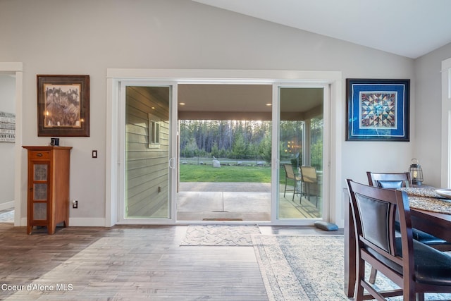 5867 W Sparrowhawk Dr, Rathdrum, ID 83858 - doorway to outside with lofted ceiling, baseboards, and wood finished floors