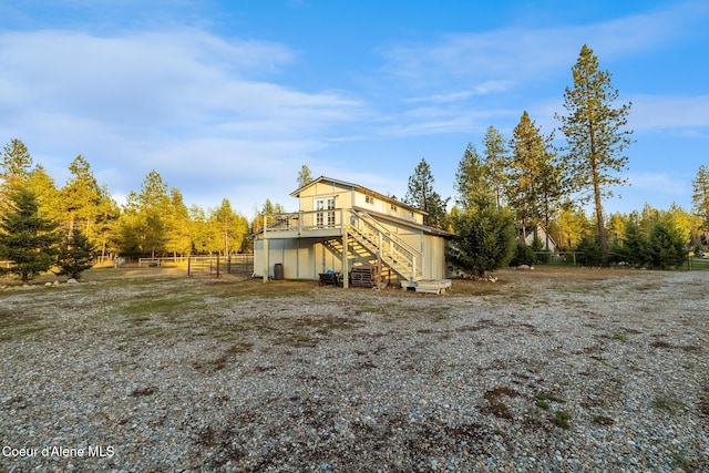 5867 W Sparrowhawk Dr, Rathdrum, ID 83858 - back of house with stairway, fence, and a deck