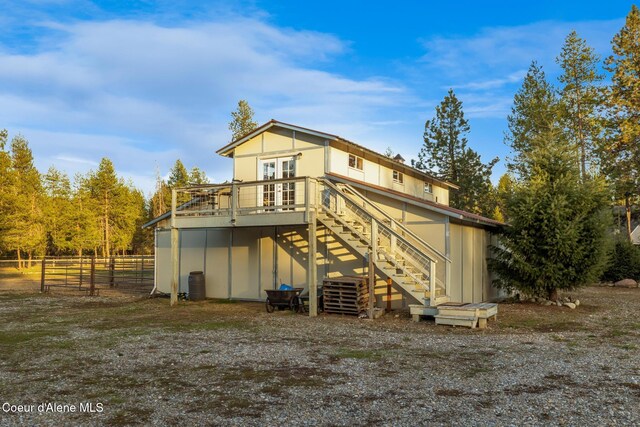 5867 W Sparrowhawk Dr, Rathdrum, ID 83858 - back of house featuring stairway, fence, and a deck
