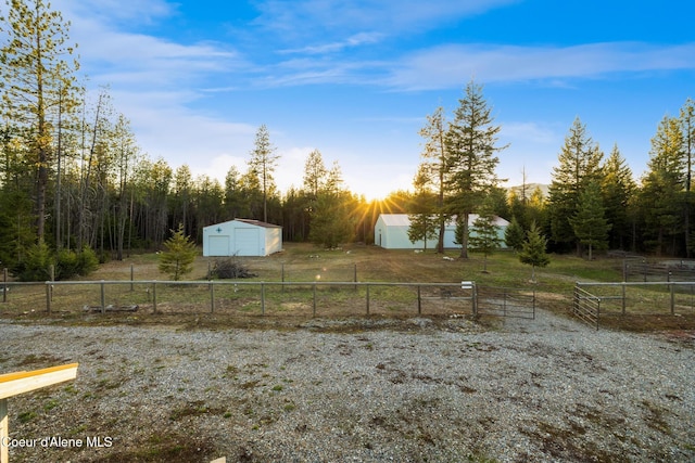 5867 W Sparrowhawk Dr, Rathdrum, ID 83858 - view of yard with an outdoor structure, fence, a rural view, and a garage