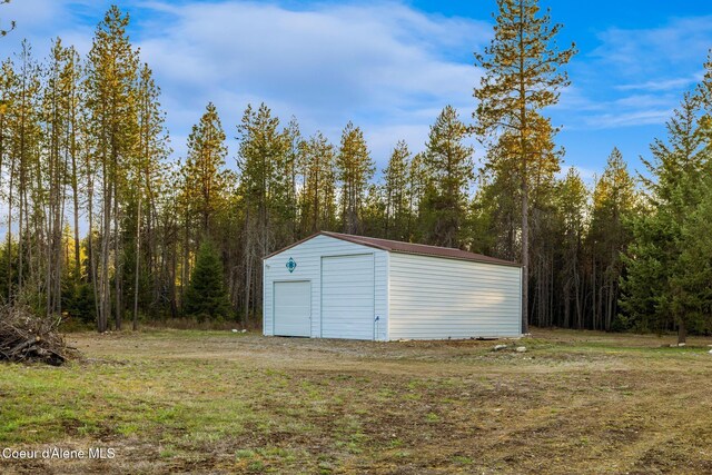 5867 W Sparrowhawk Dr, Rathdrum, ID 83858 - view of outdoor structure with an outbuilding and a wooded view