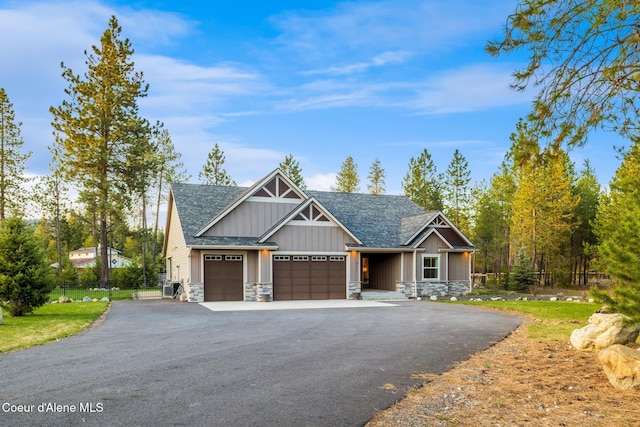 5867 W Sparrowhawk Dr, Rathdrum, ID 83858 - craftsman inspired home featuring aphalt driveway, fence, board and batten siding, stone siding, and a garage