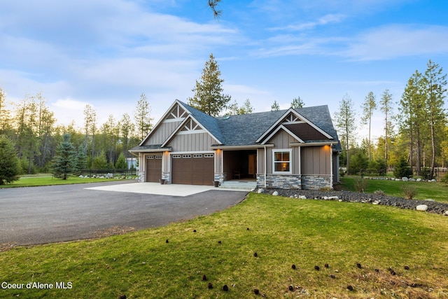 5867 W Sparrowhawk Dr, Rathdrum, ID 83858 - craftsman inspired home featuring board and batten siding, an attached garage, stone siding, and driveway
