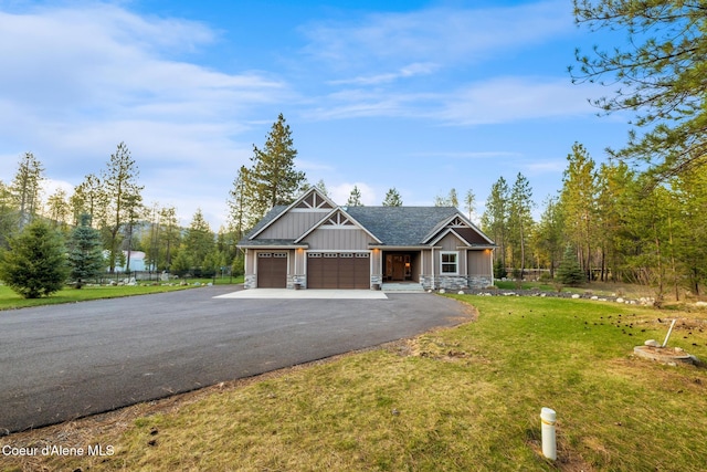 5867 W Sparrowhawk Dr, Rathdrum, ID 83858 - craftsman house with a front lawn, stone siding, an attached garage, board and batten siding, and aphalt driveway
