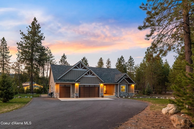 5867 W Sparrowhawk Dr, Rathdrum, ID 83858 - craftsman house with driveway, stone siding, board and batten siding, a garage, and roof with shingles
