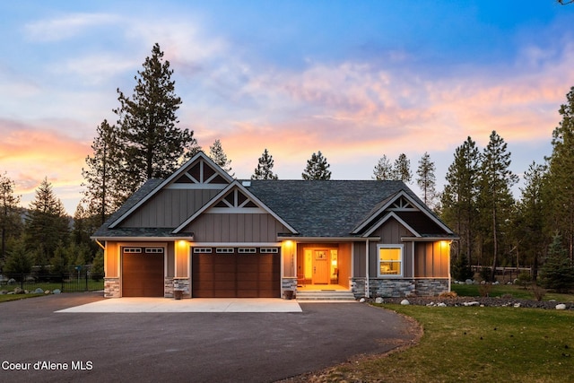 5867 W Sparrowhawk Dr, Rathdrum, ID 83858 - craftsman-style house with board and batten siding, driveway, stone siding, and a front yard