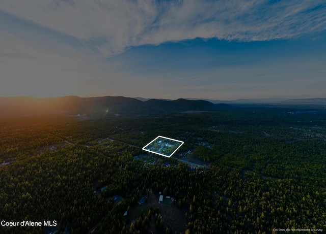 5867 W Sparrowhawk Dr, Rathdrum, ID 83858 - aerial view at dusk with a mountain view