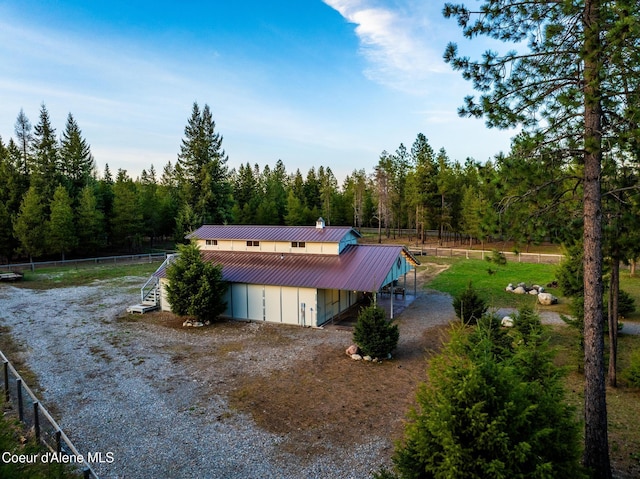 5867 W Sparrowhawk Dr, Rathdrum, ID 83858 - view of outdoor structure with a forest view, fence, and stairway