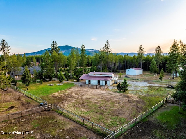 5867 W Sparrowhawk Dr, Rathdrum, ID 83858 - aerial view at dusk featuring a mountain view and a rural view