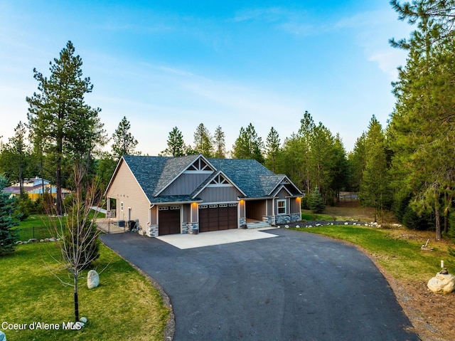 5867 W Sparrowhawk Dr, Rathdrum, ID 83858 - craftsman inspired home featuring a front lawn, driveway, fence, a garage, and board and batten siding