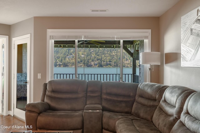 4549 S Arrow Point Dr # 207, Harrison, ID 83833 - living room featuring visible vents, wood finished floors, and a water view