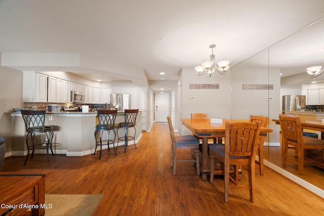 4549 S Arrow Point Dr # 207, Harrison, ID 83833 - dining area with light wood finished floors, baseboards, recessed lighting, and a chandelier