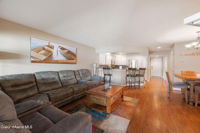 4549 S Arrow Point Dr # 207, Harrison, ID 83833 - living room with a chandelier and light wood finished floors
