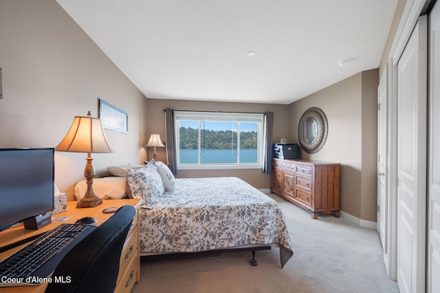 4549 S Arrow Point Dr # 207, Harrison, ID 83833 - bedroom with baseboards, light carpet, and a closet
