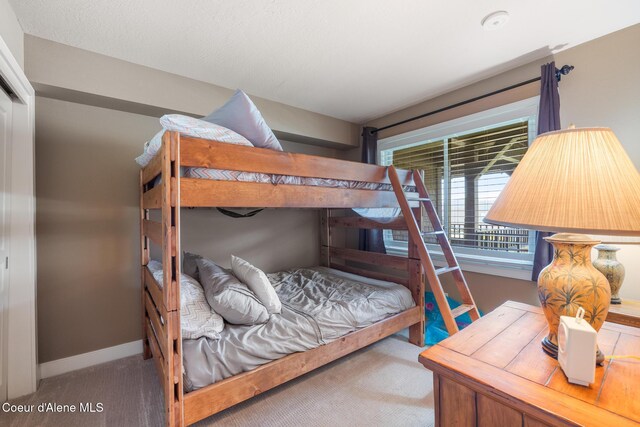 4549 S Arrow Point Dr # 207, Harrison, ID 83833 - carpeted bedroom featuring baseboards