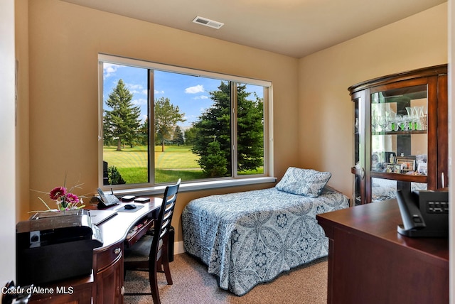 carpeted bedroom featuring visible vents