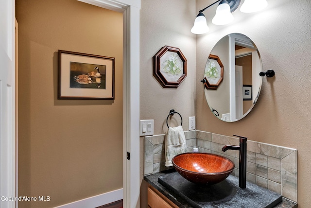 bathroom featuring decorative backsplash and vanity