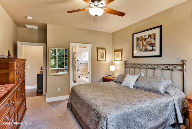 carpeted bedroom with baseboards, ensuite bath, visible vents, and a ceiling fan