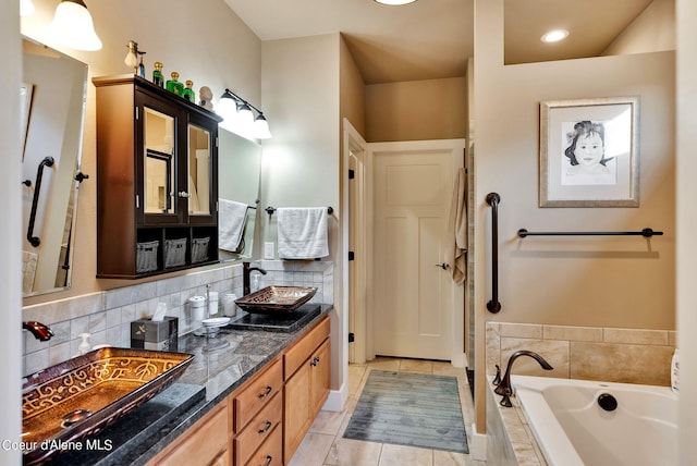 full bathroom featuring tasteful backsplash, a sink, a bath, double vanity, and tile patterned flooring