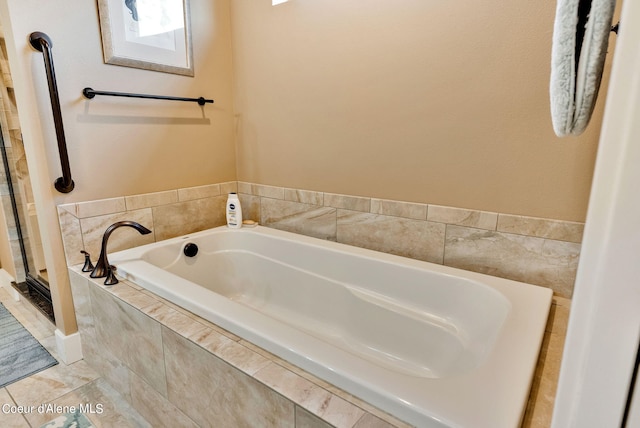 bathroom with a bath and a stall shower