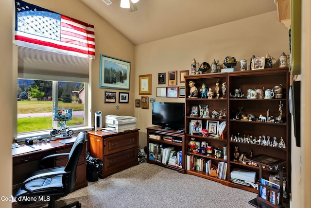 carpeted home office with ceiling fan and vaulted ceiling