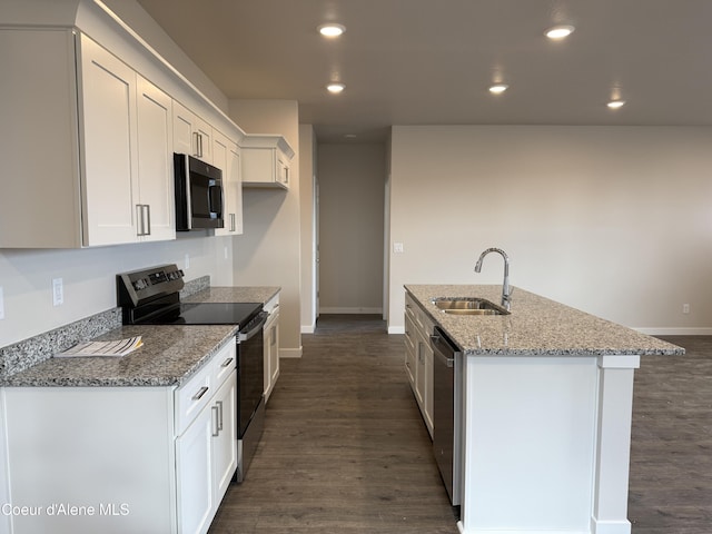 5147 E Norma Ave, Post Falls, ID 83854 - kitchen with stainless steel appliances, dark wood-style flooring, white cabinets, an island with sink, and recessed lighting