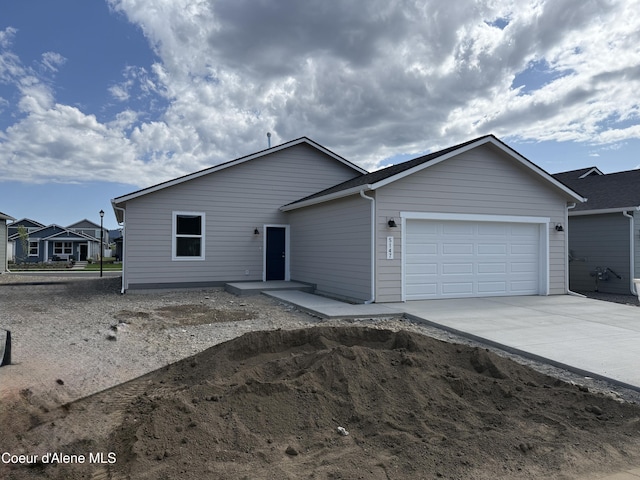 5147 E Norma Ave, Post Falls, ID 83854 - view of front facade with an attached garage and concrete driveway