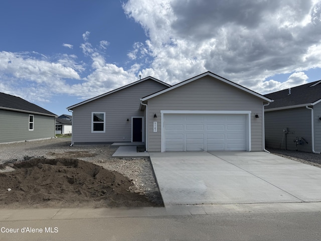 5147 E Norma Ave, Post Falls, ID 83854 - ranch-style home with an attached garage and driveway