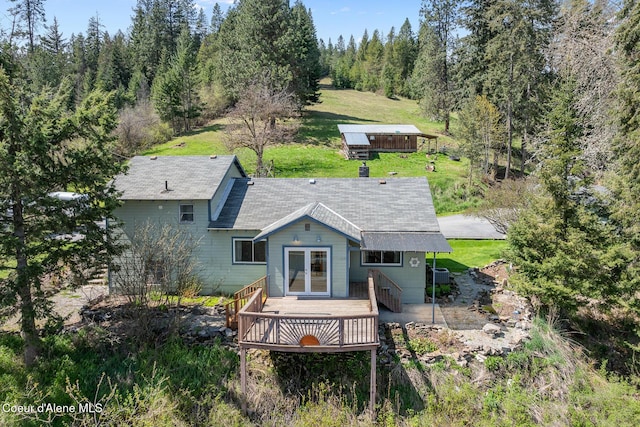 rear view of house featuring a wooden deck and french doors