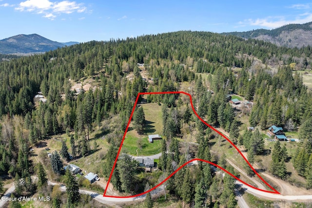bird's eye view with a wooded view and a mountain view