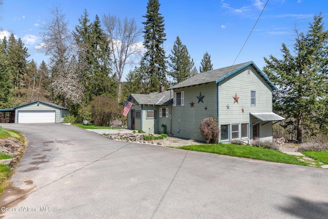 view of home's exterior with an outdoor structure and a garage