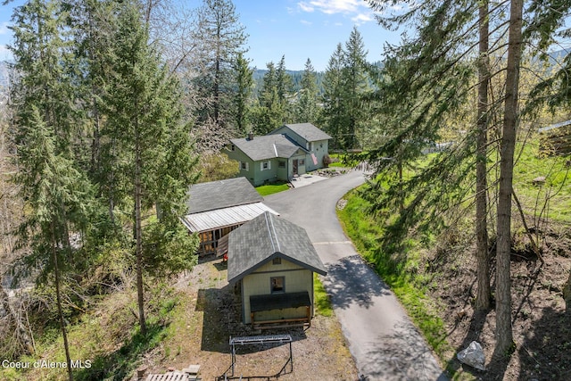 birds eye view of property with a forest view