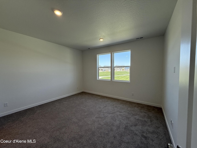 5119 E Rigel Ln, Post Falls, ID 83854 - spare room with dark carpet, a textured ceiling, and recessed lighting