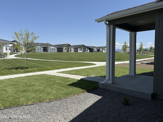 5119 E Rigel Ln, Post Falls, ID 83854 - view of grassy yard featuring a residential view and covered porch