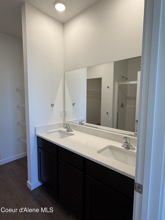 5119 E Rigel Ln, Post Falls, ID 83854 - full bath featuring a spacious closet, a shower stall, wood finished floors, and double vanity
